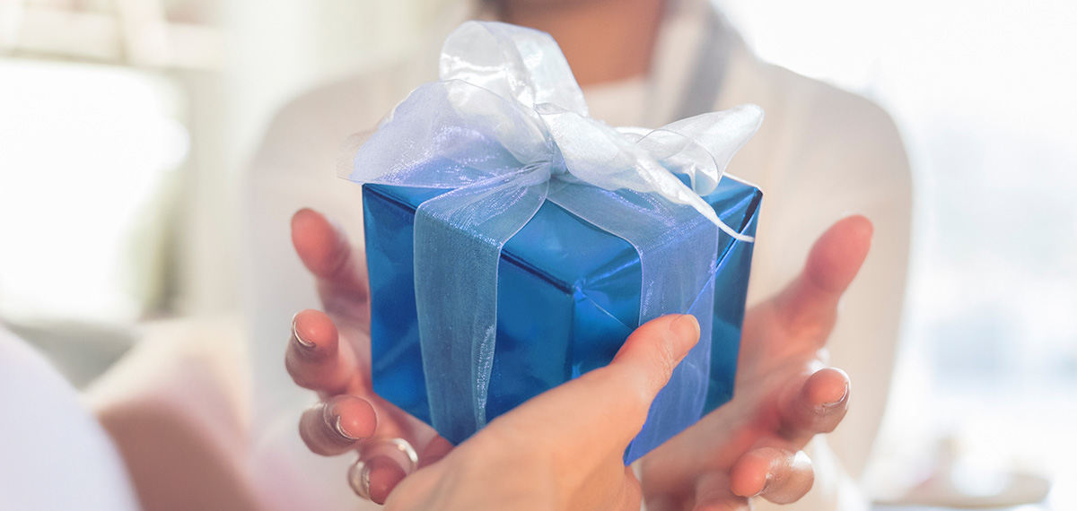 women giving each other a gift from a Boyd retail location